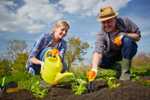 Certificate of insurance document and safety clipboard on a garden job